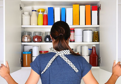 Woman opening a pantry and making plans to optimize her military eating environment with nutrition planning  