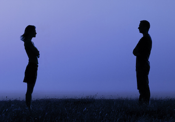 Silhouettes of couple facing each other highlighting the importance of effective communication in relationships 