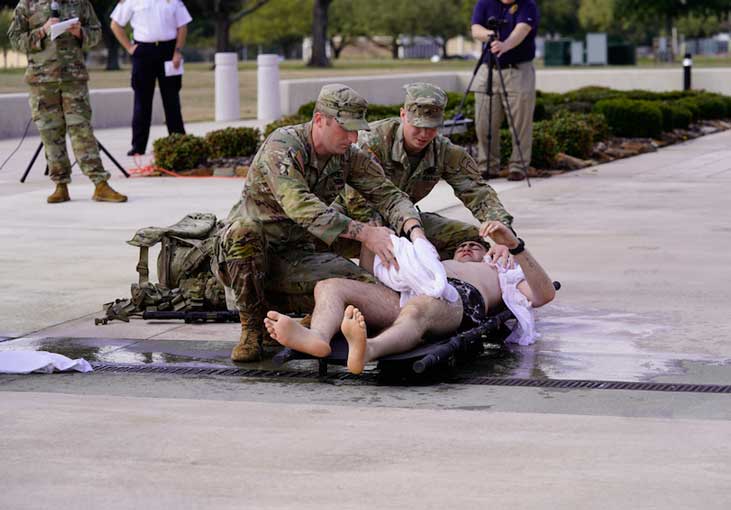 Soldiers demonstrating treatment for exertional heat illness. Photo by Ron Mooney. Martin Army Community Hospital