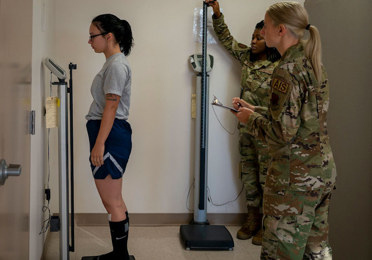 Fitness assessment cell technicians measure Airman’s weight and height prior to conducting a fitness assessment (U.S. Air Force photo by Senior Airman Kimberly Barrera)