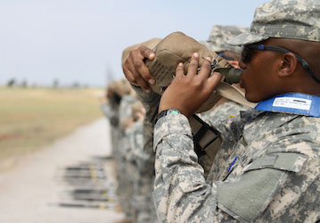 Service Member drinking water from his canteen follows HPRC performance nutrition guidelines to stay hydrated between trainin