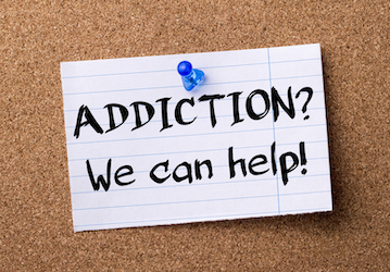 Note about getting help for addiction hangs on cork board and connects Coasties to Substance Abuse Prevention Program to impr