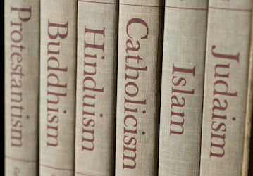 Book spines reading different religions highlights the variety of HPRC faith based resources for military service members 