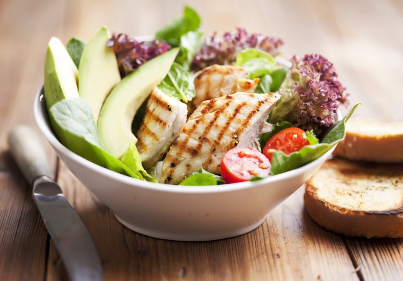 Bowl of grilled chicken salad with avocados