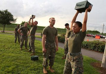 Marines lifting ammo cans over their heads during a fitness test develop physical and mental stamina for optimized military p