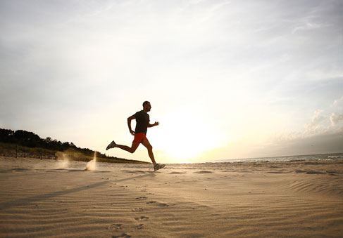 Silhouette of man running on a beach promotes VA program for healthy weight management through physical exercise  