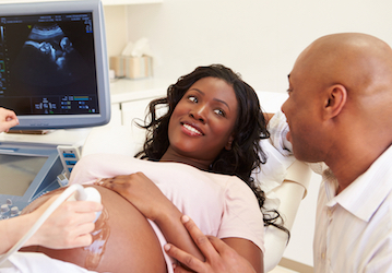 Pregnant woman and her partner at an ultrasound appointment refer to HPRC for military service-specific pregnancy and parenth