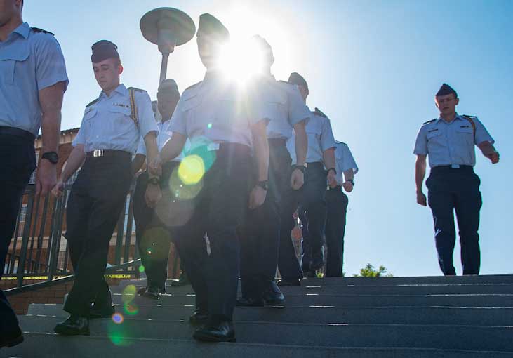 Platoon of Air Force Reserve Officer's Training Corps cadets practice with bright sun in background. Photo by Ken Scar.