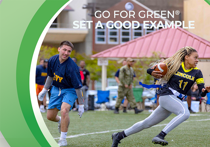 Two people playing flag football. Go for Green. Set a good example.
