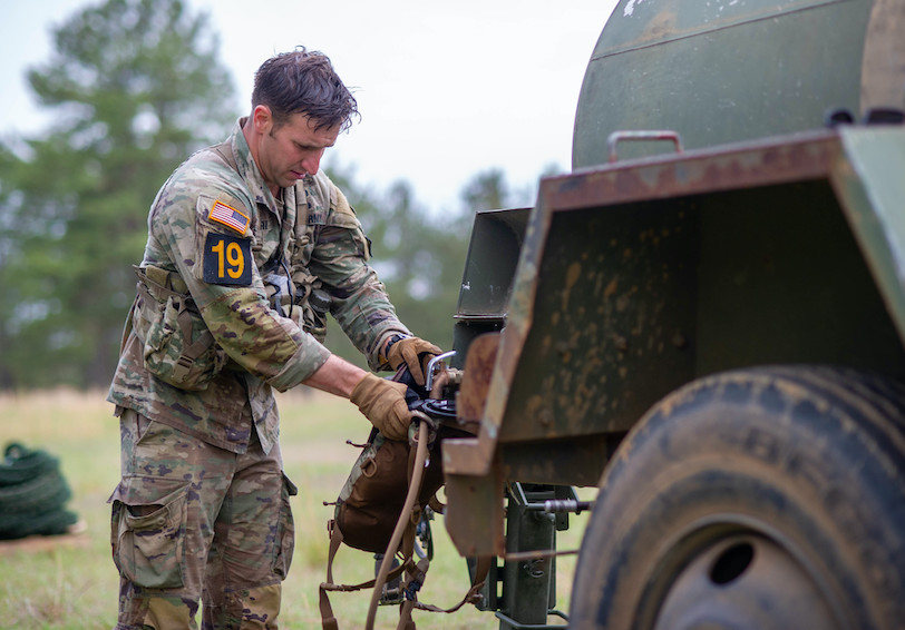 A Service Member fills a water source. (U.S. Army photo by Sgt. Henry Villarama)