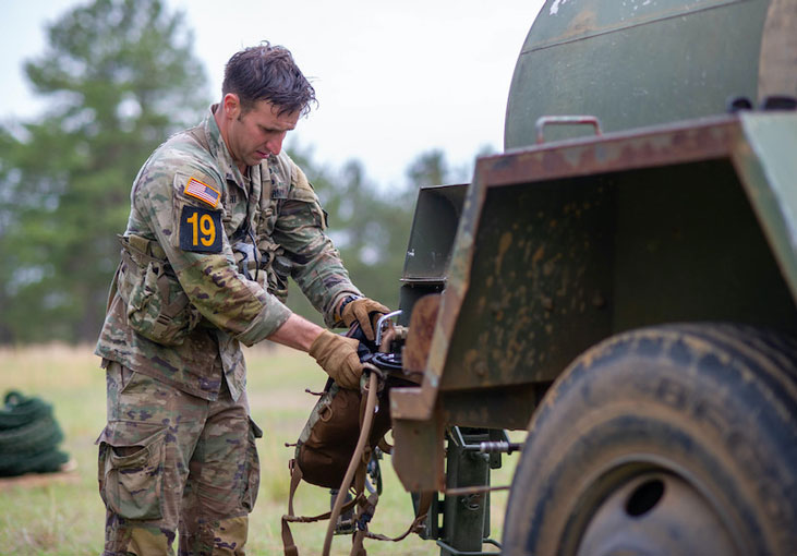 A Service Member fills a water source   U S  Army photo by Sgt  Henry Villarama 