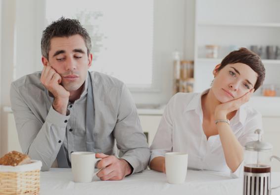 Bored couple sitting at the counter with a cup of coffee need HPRC resources for improved relationship communication and inti
