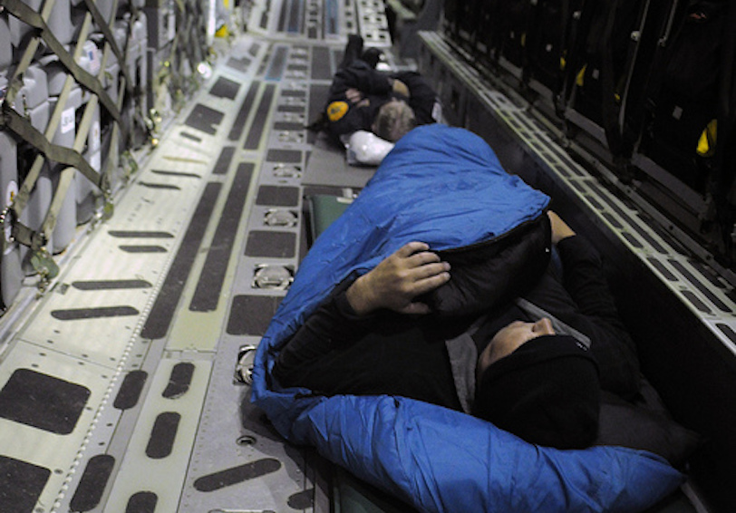 Airmen sleeping in back of cargo plane  U S  Air Force photo by Tech  Sgt  Daniel St  Pierre 