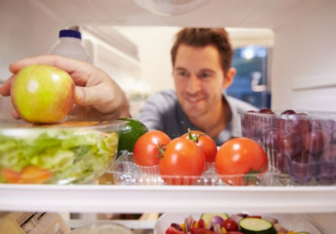 Service member chooses performance nutrition from array of healthy foods in their refrigerator 