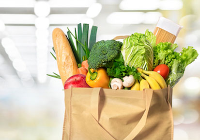 Grocery bag filled with healthy foods emphasizing the importance of performance nutrition and proper fuel 
