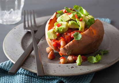 Sweet potato loaded with healthy toppings highlighting the significance of proper fuel and performance nutrition. 