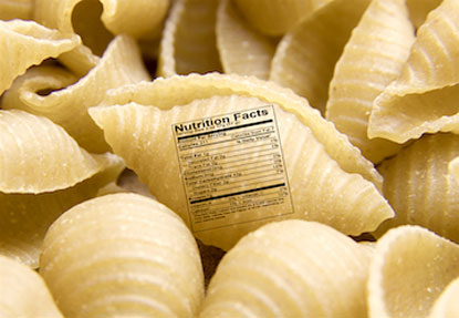 Close up of uncooked shell pasta noodle with nutrition label to show that performance nutrition choices optimize military wor