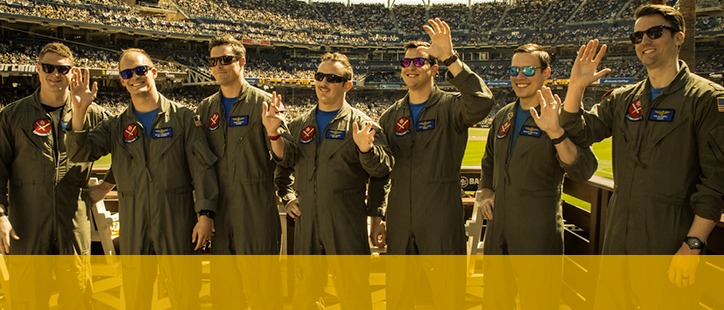Soldiers waving at the football field stadium